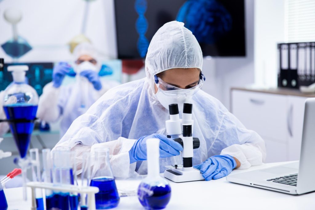 Laboratory technician with samples in protective clothing