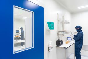 Laboratory technician inspecting an environmental monitoring plate